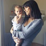 A loving moment between a mother and her child in an indoor setting, fostering connection and warmth.